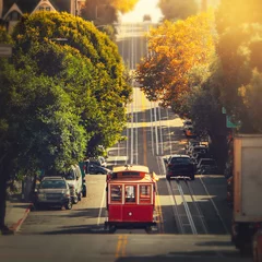 Gartenposter Traditional  retro cable tram riding on famous street in the middle of day in October, San Francisco, California, USA © Glebstock