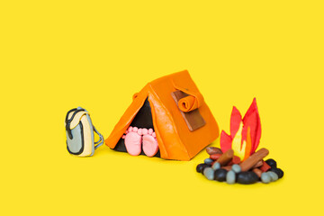 Plasticine hiking elements on a yellow background.