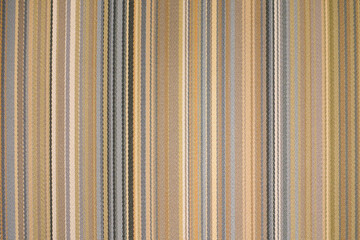 colorful earth tone fabric background with soft faded rainbow-colored vertical stripes