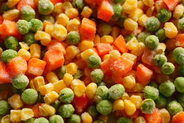 Close-up of frozen mixed vegetables. carrots, corn, green peas.