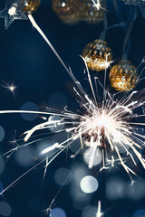 Burning christmas sparkler with bokeh background.Merry Christmas and happy new year concept background.