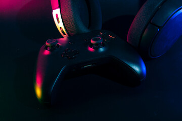 gamer playing the online game with joystick controller in neon glow dark cyberpunk room, gaming and...
