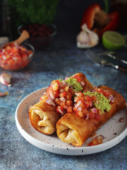 A typical dish of Mexican cuisine - Chimichanga, made of tortilla with different ingredients	