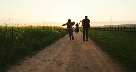 Farm family, walking with child and holding hands on sustainable organic farming healthy plant crop harvest for sustainability. Agriculture farmer, girl kid playing and mom on fun sunset nature walk