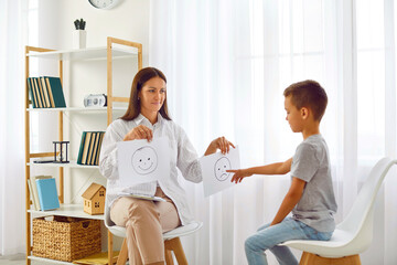 Psychologist or therapist working with child in office. Little boy meets with school counsellor for...