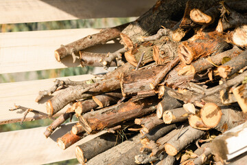 Stocks of wooden firewood close-up. Preparing for winter, world energy crisis