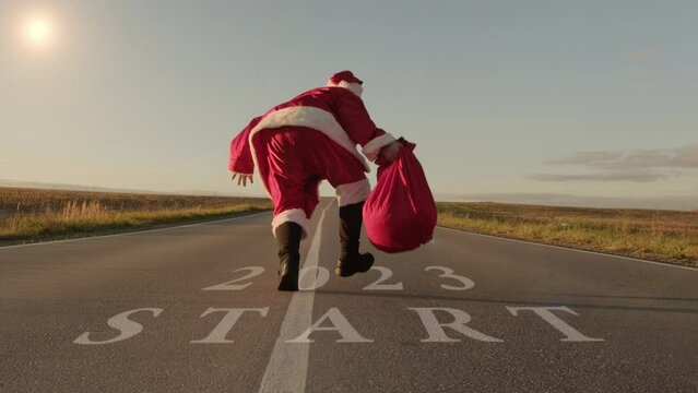 Santa Claus is running in new year 2023. Start of New Year and Merry Christmas.