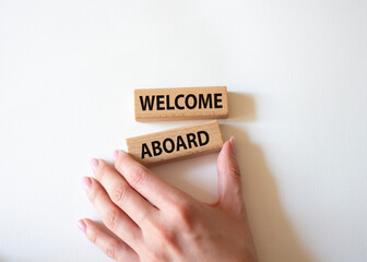 Welcome aboard symbol. Concept word Welcome aboard on wooden blocks. Beautiful white background. Businessman hand. Business and Welcome aboard concept. Copy space