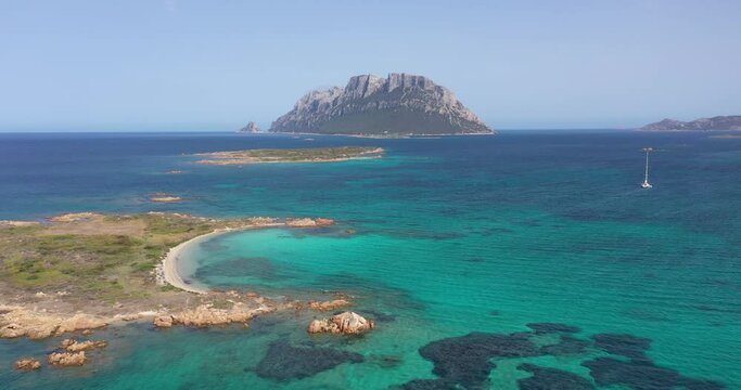 Aerial view of Tavolara Island surrounded by a clear and turquoise sea in Sardinia, Italy.