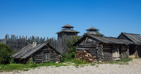 Shchurovskoye settlement with ancient wooden houses among green trees on a sunny summer day and a space for copying in Suzdal Russia