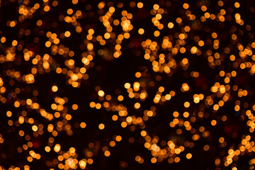 Fototapeta na wymiar Gold bokeh circles on a black background. Christmas colorful lights. Overlay