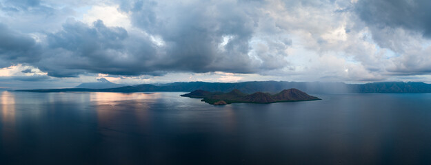 Clouds drift over beautiful, isolated islands found in the Lesser Sunda Islands of Indonesia. This tropical region is home to an extraordinary array of marine biodiversity.
