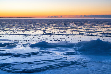 Fototapeta na wymiar Sunset over the frozen sea. Pörkenäs, Finland