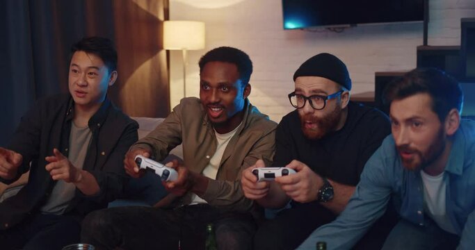 Men friends having fun playing video games and competing