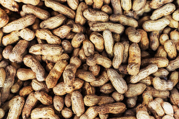 Lots of unshelled peanuts at the grocery store. Close-up