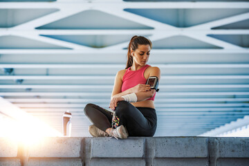 Sportswoman using mobile phone after workout
