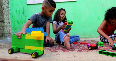 Hispanic children from south america playing with toys at backyard