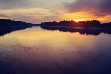 Obraz premium A beautiful and tranquil sunset over a river.