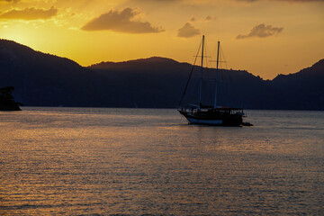 moored sailboat at sunset