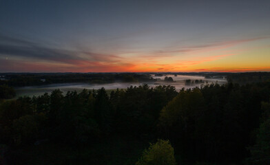An autumn evening in the fields of Latgale is decorated with fog and sunset.