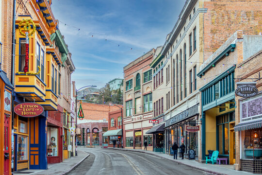 Buildings lining Main Street on a clear day at the edge of Bisbee, Arizona.