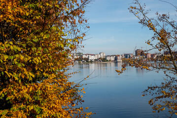 Obraz premium view of the lake and houses autumn yellow leaves reed bridge