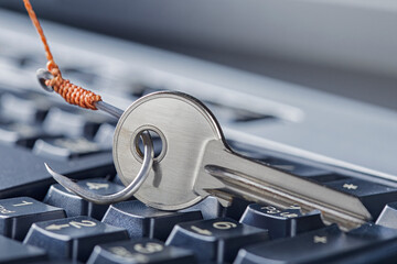 phishing, hacking personal data and money , key and hook on computer keyboard.