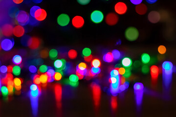 Abstract background with colorful sparkling bokeh on a dark background. Holiday concept