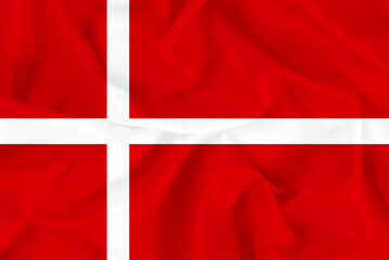 Beautiful national red and white flag of Denmark on fabric background