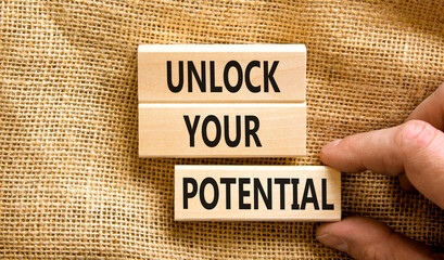 Unlock your potential symbol. Concept words Unlock your potential on wooden blocks. Businessman hand. Beautiful canvas background. Business, psychological unlock your potential concept. Copy space.
