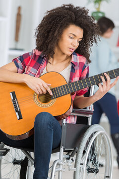 a disabled girl playing guitar