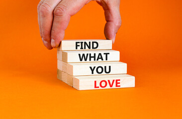 Find what you love symbol. Concept words Find what you love on wooden blocks. Beautiful orange table orange background. Businessman hand. Business, psychological find what you love concept. Copy space