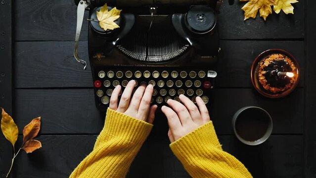 Hand of young woman writer on old typewriter