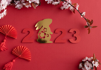 Fototapeta Chinese New Year, year of the rabbit. Year 2023 with golden rabbit and plum blossom fans. Copy space. obraz