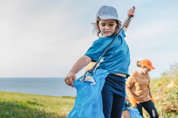 Cute girl picking up garbage for environment campaign