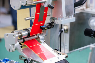 Fragment of the conveyor of sticking labeling machine. Abstract industrial background.