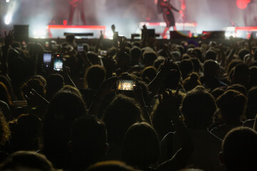 Fototapeta na wymiar People with mobile phones at a concert. Hands with mobile phone. public at a concert takes photos with the mobile.