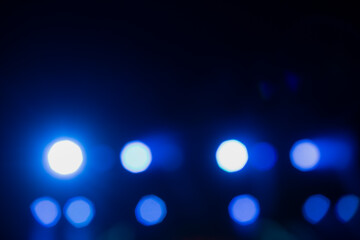 Stage lighting. Spotlights with colored lights on a stage. Artificial lighting. Black background and blur.