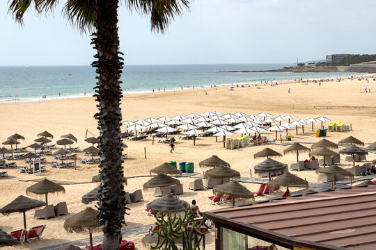 People enjoying their time on the beach in Carcavelos, Portugal