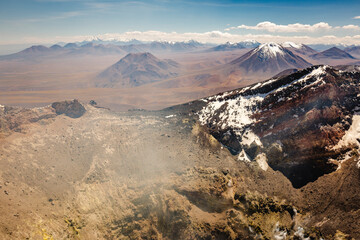 Atacama desert, snowcapped Lascar volcano crater and arid landscape in Chile © Aide