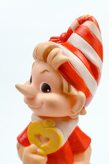 Old rubber toy Pinocchio on a white background. USSR toy