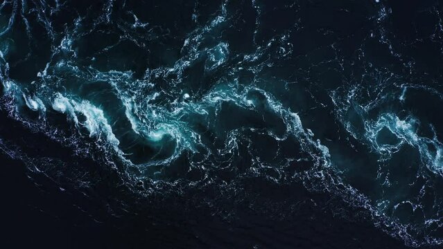 Turquoise current and swirls in Saltstraumen maelstrom - aerial top down view