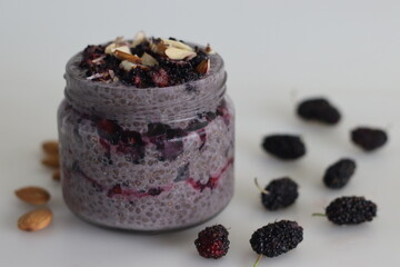 Overnight Oats Chia pudding served with mulberries and chopped almonds. A healthy breakfast with no cooking involve
