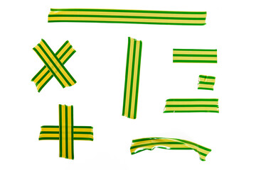 A set of pieces of torn green and yellow striped duct tape isolated on white