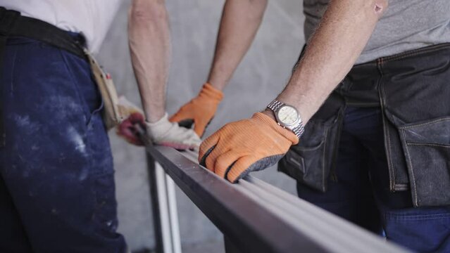 workers install a window in a new home
