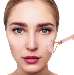 Young woman using pink quartz gua sha roller for face.