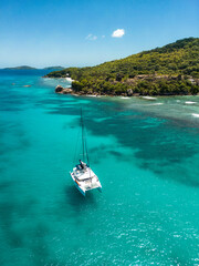 Aerial drone of luxury yachts anchored in tropical exotic island with crystal clear turquoise sea and 