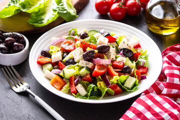 Greek salad. Fresh salad with tomato, cucumber, feta cheese and olives. Close up.