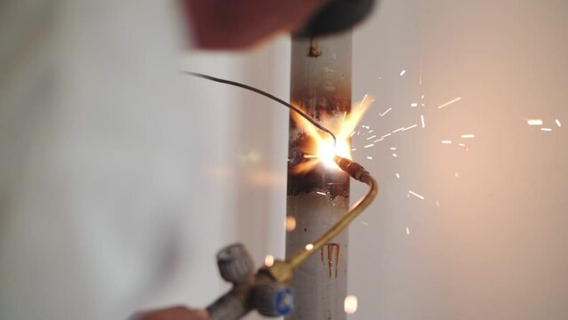 soldering a pipe with gas welding