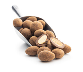 Almonds in chocolate coated in cocoa isolated in scoop on white background.